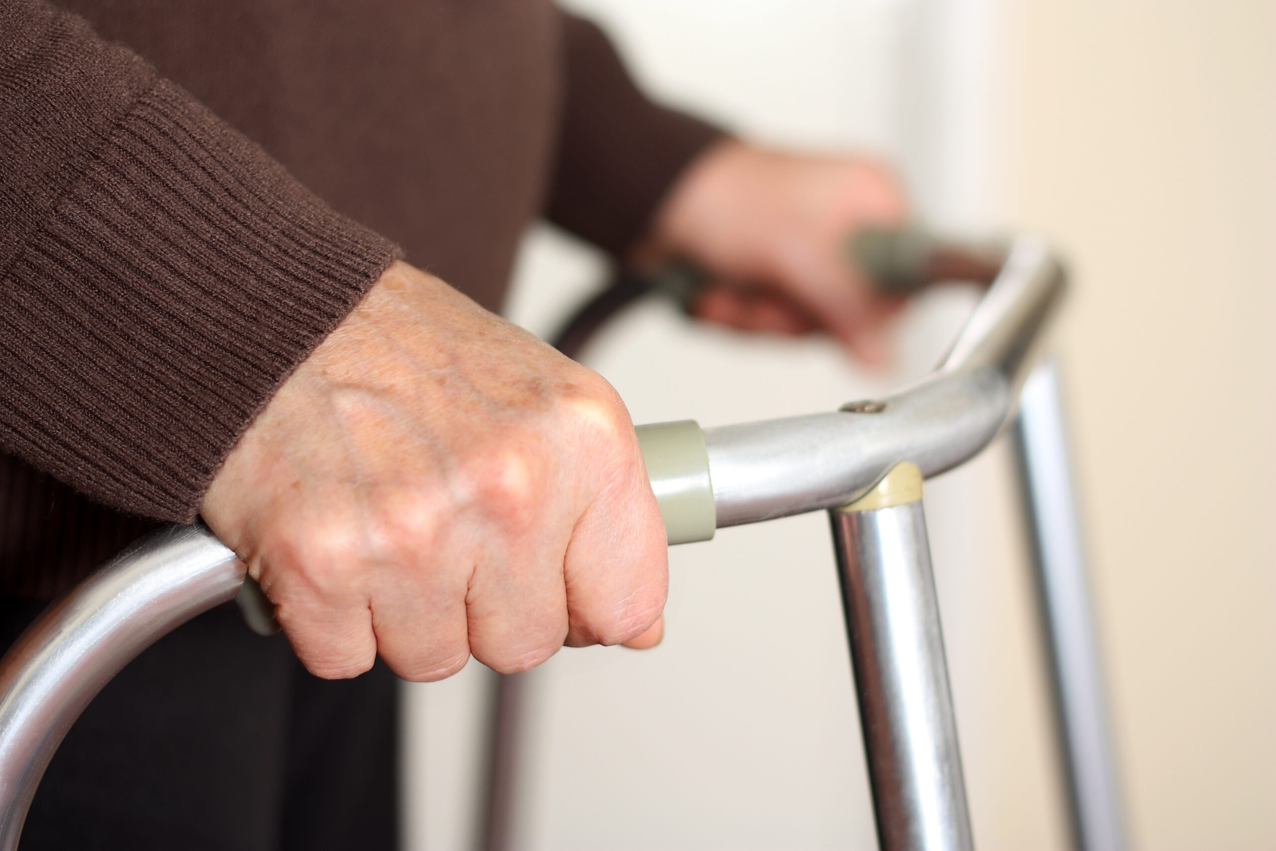 Elderly person using a walker.